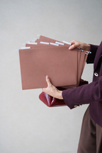 Hands holding a fanned stack of CUBBLI expansion files