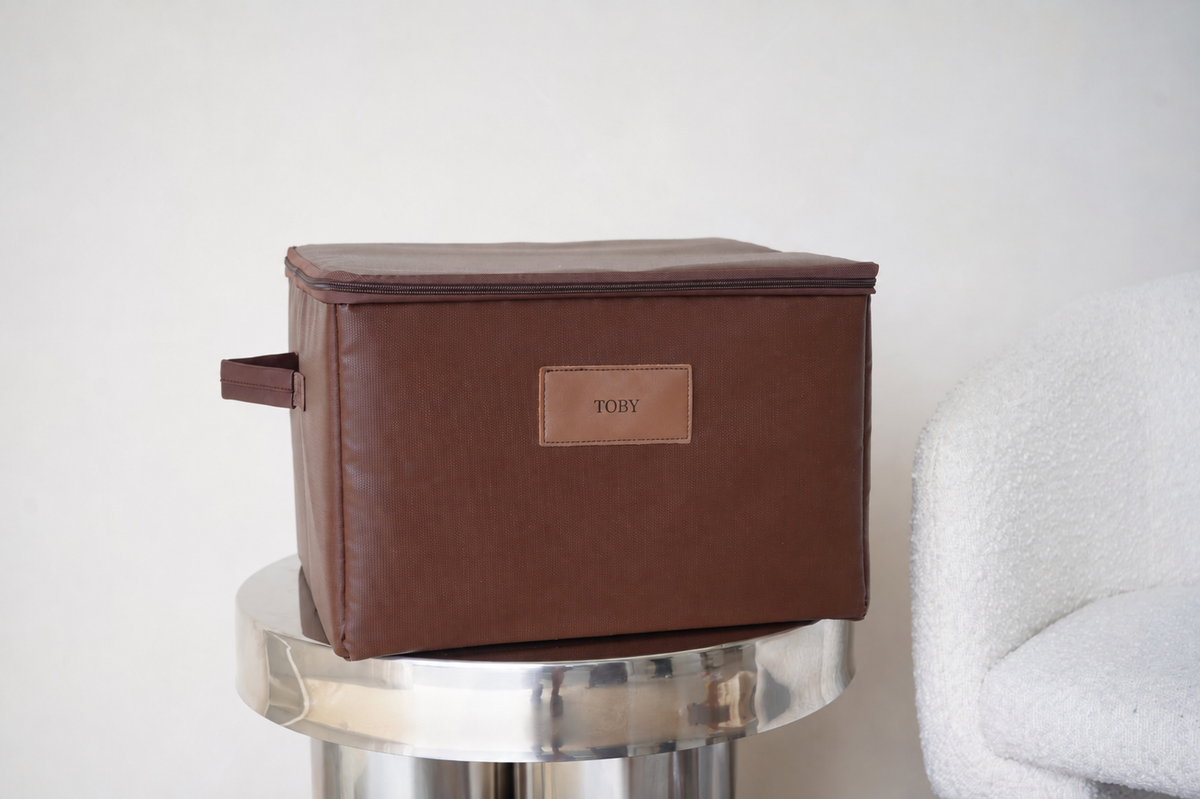 CUBBLI keepsake box in Chocolate brown, closed, on a marble side table