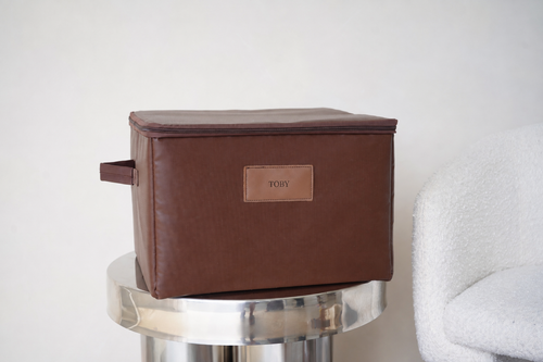 CUBBLI keepsake box in Chocolate brown, closed, on a marble side table