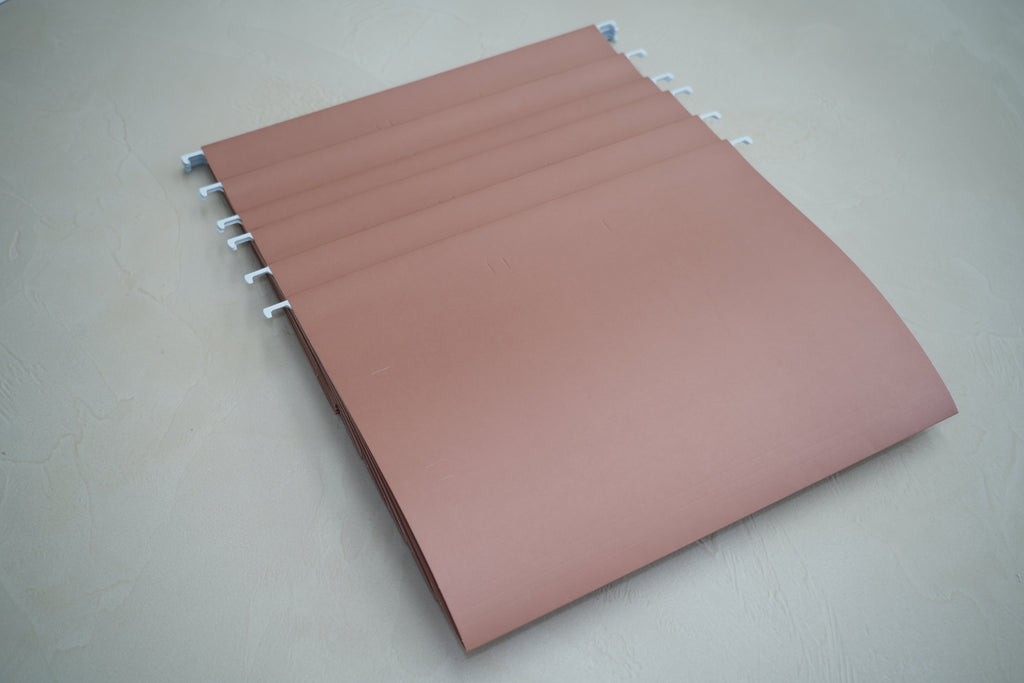 Close-up of a CUBBLI file folder with an insert tab, angled view