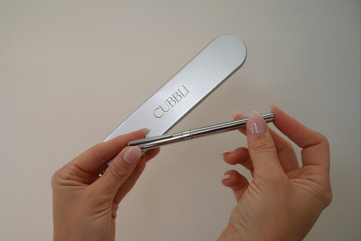CUBBLI Heritage chrome pen resting on a keepsake box lid engraved with the CUBBLI logo